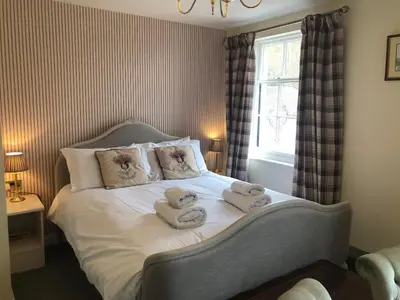 a bedroom with a bed with towels on it at Rhydspence in Hay-on-Wye