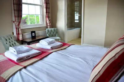 a bedroom with a bed with towels on it at Rhydspence in Hay-on-Wye
