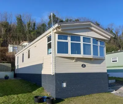 a house with a large window on the side of it at Wonderful 2 bedroom mobile home in Aberystwyth