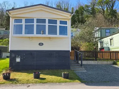 a house with a large window on the side of it at Wonderful 2 bedroom mobile home in Aberystwyth