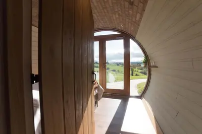 a hallway of a house with a circular window at Hares View in Rhayader