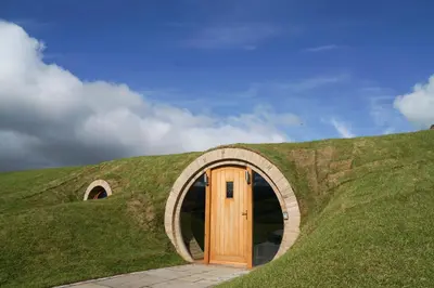 a house with a door in a grassy hill at Badgers View in Rhayader