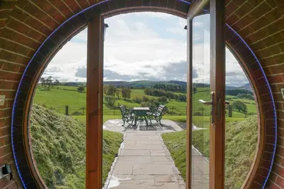 an arched doorway of a building with a table and chairs at Badgers View in Rhayader