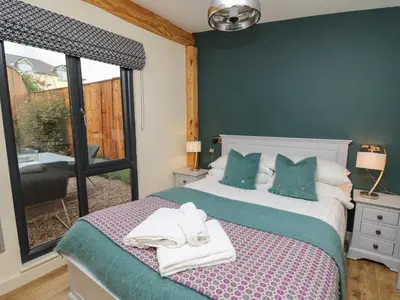 a bedroom with a bed with towels on it at Celyn in Welshpool