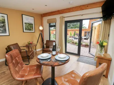 a living room with a table and chairs at Rhosyn in Welshpool