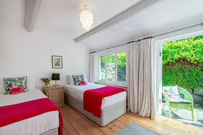two beds in a room with a window at Stylish home from home with great views in Harlech