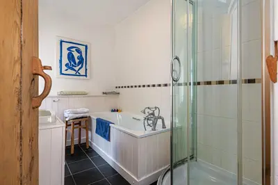 a bathroom with a bath tub and a shower at Stylish home from home with great views in Harlech