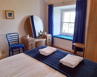 a bedroom with a bed with two towels on it at Stylish home from home with great views in Harlech