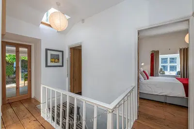 a staircase leading to a bedroom with a bed at Stylish home from home with great views in Harlech