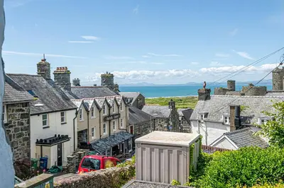 a view of a town with houses and the ocean at Stylish home from home with great views in Harlech