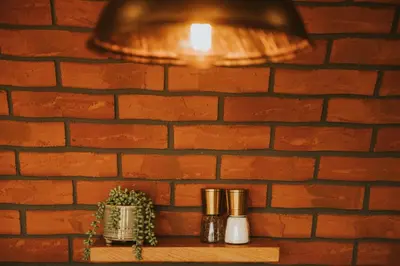 a lamp on a shelf next to a brick wall at Otters View in Rhayader