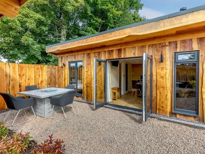 a small wooden building with a table and chairs at Rhosyn - Uk40260 in Llangadfan
