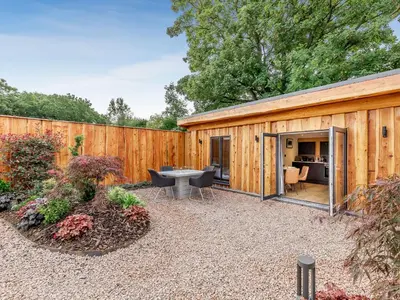 a backyard with a wooden shed with a table and chairs at Celyn - Uk40258 in Llangadfan