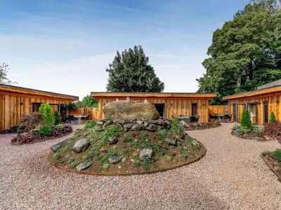 a garden with a rock in front of a building at Celyn - Uk40258 in Llangadfan