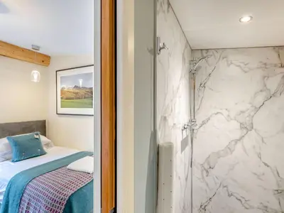 a bathroom with a shower and a bed in a room at Celyn - Uk40258 in Llangadfan