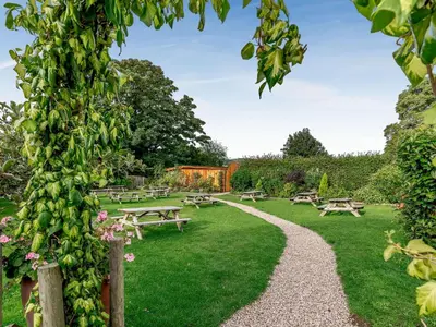 a park with picnic tables and benches in the grass at Pansi - Uk40263 in Llangadfan
