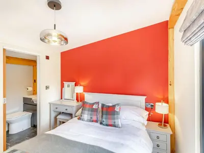 a bedroom with a red accent wall at Pansi - Uk40263 in Llangadfan