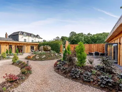 a garden with a fence and a house at Daffodil - Uk40266 in Llangadfan