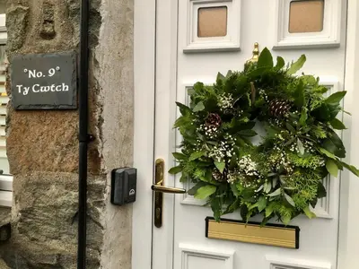 a door with a christmas wreath on it at Ty Cwtch in Dolgellau