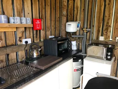a kitchen counter with a microwave and a coffee maker at Shepherds Hut at The Retreat in Oswestry