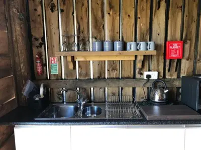 a kitchen with a sink and a counter top at Shepherds Hut at The Retreat in Oswestry