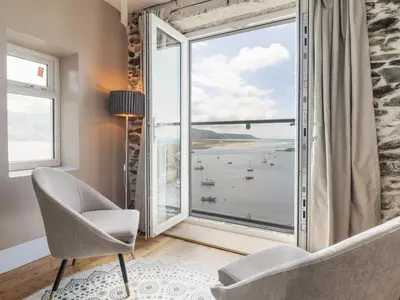 a room with a large window with a view of the ocean at Windycroft in Barmouth
