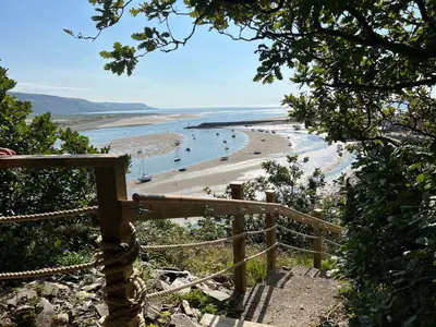 a view of a beach with people in the water at Windycroft in Barmouth