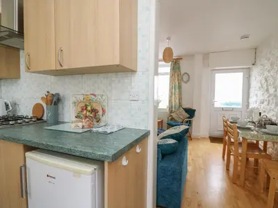 a kitchen and living room with a counter top at Rowan Cottage in Builth Wells
