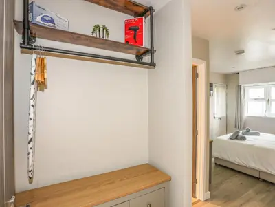 a bedroom with a bed and a shelf on the wall at Bryn Y Mor in Tywyn