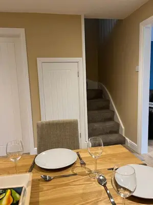 a table with two plates and wine glasses on it at Beautiful mid wales cottage in Garth