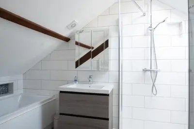 a bathroom with a sink and a shower and a tub at Loyalty in New Quay