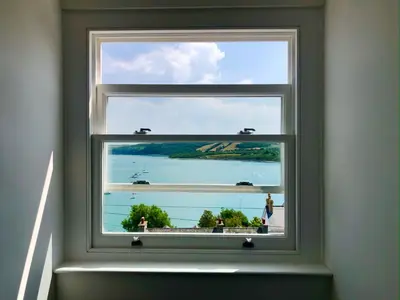 a window in a room with a view of the ocean at Loyalty in New Quay