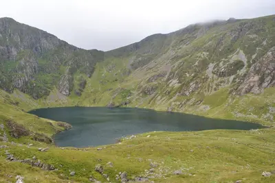 a lake in the middle of a mountain at Dolafon in Llanbedr