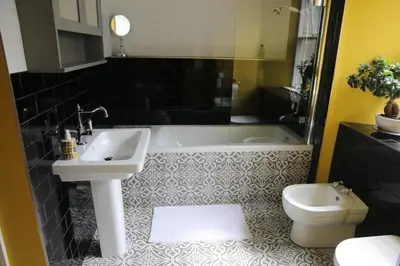a bathroom with a sink and a tub and a toilet at Dolafon in Llanbedr