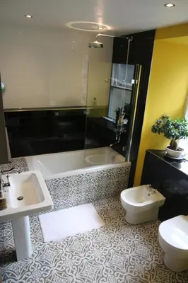 a bathroom with a sink and a tub and a toilet at Dolafon in Llanbedr