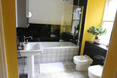 a bathroom with a sink and a tub and a toilet at Dolafon in Llanbedr