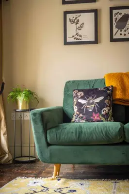 a green couch sitting in a living room at The New White Lion in Llandovery