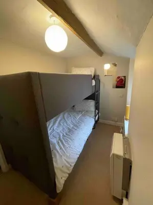 a room with a bed in the corner of a room at Yew Tree Cottage, 3 bedroom, 4 Church Row Defynnog in Devynock