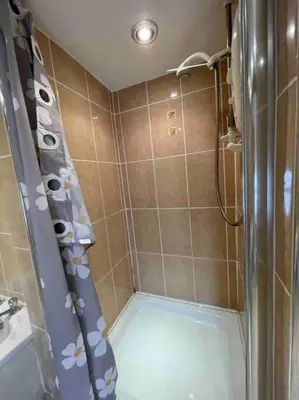 a bathroom with a shower with a shower curtain at Yew Tree Cottage, 3 bedroom, 4 Church Row Defynnog in Devynock