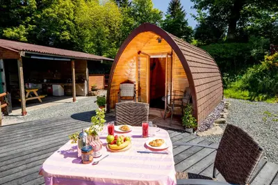a table with food in front of a tent at Ty Grug Pods in Bryngwyn