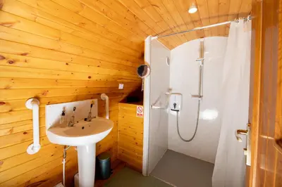 a bathroom with a sink and a shower at Ty Grug Pods in Bryngwyn