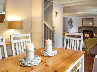 a dining room table with candles on top of it at Penlan Cottage in Cwrt-newydd