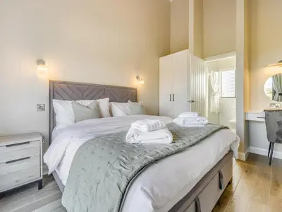 a bedroom with a large bed with towels on it at The Warne - Uk45018 in Mochdre