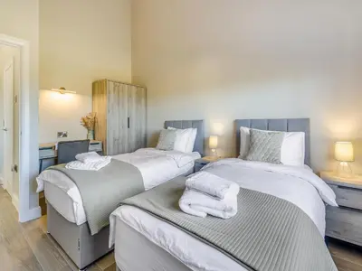 a bedroom with two beds with towels on them at The Warne - Uk45018 in Mochdre