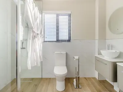 a white bathroom with a toilet and a sink at The Warne - Uk45018 in Mochdre