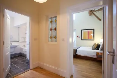 a bedroom with a bed and a bathroom at The Clive Arms in Ludlow