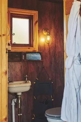 a bathroom with a sink and a toilet and a window at Curious Calf in Leominster