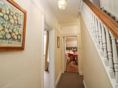 a hallway with a painting of fruit on the wall at Dinham Court in Ludlow