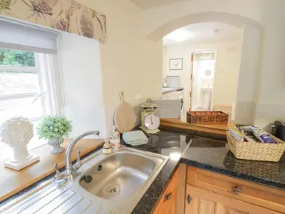 a kitchen with a sink and a window at Grove Cottage in Leominster