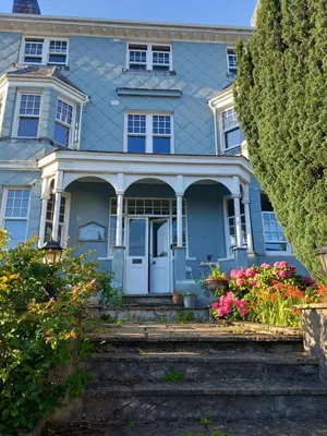 a blue house with flowers in front of it at Northampton House in Llanwrtyd Wells